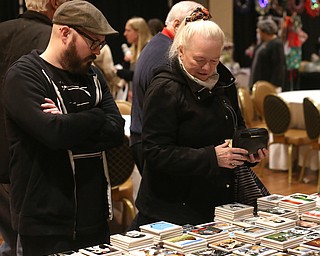 Karin McKinney(right) and her son, Rob McKinney of Warren look at custom coasters during a holiday craft show and third annual Tuba Christmas, Sunday, Dec. 3, 2017, at Stambaugh Auditorium in Youngstown...(Nikos Frazier | The Vindicator)