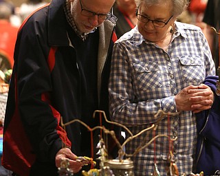 Janet Formichelli and husband Art Rothenberg of Canfield look at Christmas decorations during a holiday craft show and third annual Tuba Christmas, Sunday, Dec. 3, 2017, at Stambaugh Auditorium in Youngstown...(Nikos Frazier | The Vindicator)