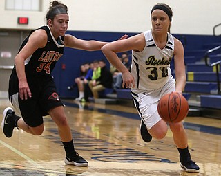 Lowellville's Maddie Warren (32) dribbles towards the basket as Mineral Ridge's Sarah Pezzenti (34) chases during the first quarter as Mineral Ridge High School takes on Lowellville High School, Monday, Dec. 4, 2017, at Lowellville High School in Lowellville. Mineral Ridge won 45-33...(Nikos Frazier | The Vindicator)..