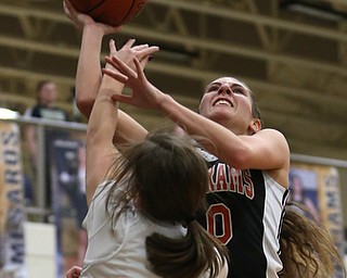 Mineral Ridge's Taryn Kolesar (10) goes up for a layup over Lowellville's Kennedy Kelly (5) during the fourth quarter as Mineral Ridge High School takes on Lowellville High School, Monday, Dec. 4, 2017, at Lowellville High School in Lowellville. Mineral Ridge won 45-33...(Nikos Frazier | The Vindicator)..