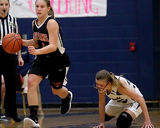 Mineral Ridge's Nevaeh Cruz (1) charges towards the net as Lowellville's Emily McGarvey (35) recovers from a collision on the court during the fourth quarter as Mineral Ridge High School takes on Lowellville High School, Monday, Dec. 4, 2017, at Lowellville High School in Lowellville. Mineral Ridge won 45-33...(Nikos Frazier | The Vindicator)..