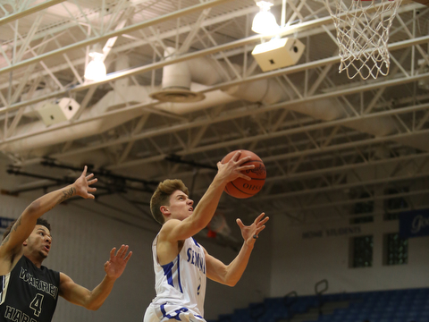 Poland's Mike Diaz (2) goes up for a layup as Harding's Chris Hughes (4) tries to block his shot from behind in the first quarter of an AAC high school basketball game, Tuesday, Dec. 5, 2017, in Poland. Poland won 57-40...(Nikos Frazier | The Vindicator)..