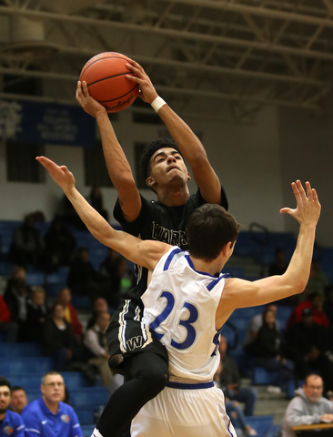 Harding's Dom McGhee (23) goes up for a layup over Poland's Michael Cougras (23) in the second quarter of an AAC high school basketball game, Tuesday, Dec. 5, 2017, in Poland. Poland won 57-40...(Nikos Frazier | The Vindicator)..