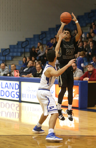 Harding's Dom McGhee (23) goes up for three as Poland's Braeden O'Shaugnessy (3) attempts to block his shot in the second quarter of an AAC high school basketball game, Tuesday, Dec. 5, 2017, in Poland. Poland won 57-40...(Nikos Frazier | The Vindicator)..