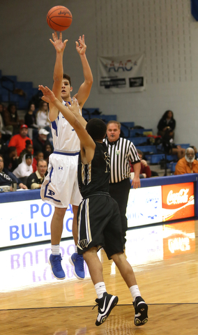 Poland's Braeden O'Shaugnessy (3) goes up for three over Harding's Trivell Trimble (11) in the third quarter of an AAC high school basketball game, Tuesday, Dec. 5, 2017, in Poland. Poland won 57-40...(Nikos Frazier | The Vindicator)..
