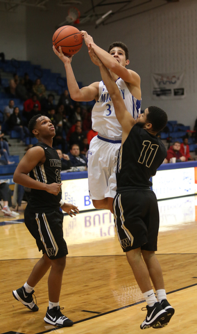 Poland's Braeden O'Shaugnessy (3) goes up for a layup over Harding's Trivell Trimble (11) in the third quarter of an AAC high school basketball game, Tuesday, Dec. 5, 2017, in Poland. Poland won 57-40...(Nikos Frazier | The Vindicator)..