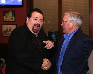 Mahoning County Commissioner Anthony Traficanti greets Boardman Police Chief Jack Nichols during a retirement party honoring Chief Nichols, Wednesday, Dec. 6, 2017, at Magic Tree Pub & Eatery in Boardman. Chief Nichols will officially retire on December 31, after having served 40 years with the Boardman Police Department...(Nikos Frazier | The Vindicator)
