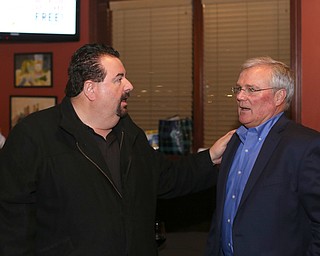 Mahoning County Commissioner Anthony Traficanti greets Boardman Police Chief Jack Nichols during a retirement party honoring Chief Nichols, Wednesday, Dec. 6, 2017, at Magic Tree Pub & Eatery in Boardman. Chief Nichols will officially retire on December 31, after having served 40 years with the Boardman Police Department...(Nikos Frazier | The Vindicator)