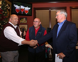 Trustee Larry Moliterno shakes Boardman Police Chief Jack Nichols' hand during a retirement party honoring Chief Nichols, Wednesday, Dec. 6, 2017, at Magic Tree Pub & Eatery in Boardman. Chief Nichols will officially retire on December 31, after having served 40 years with the Boardman Police Department...(Nikos Frazier | The Vindicator)