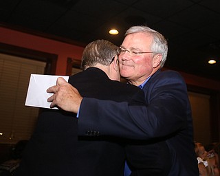 Boardman Police Chief Jack Nichols hugs Trustee Tom Costello during a retirement party honoring Boardman Police Chief Jack Nichols, Wednesday, Dec. 6, 2017, at Magic Tree Pub & Eatery in Boardman. Chief Nichols will officially retire on December 31, after having served 40 years with the Boardman Police Department...(Nikos Frazier | The Vindicator)