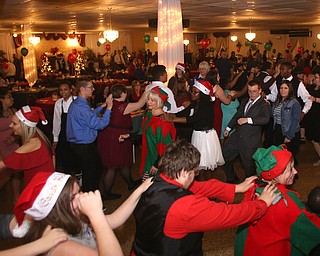 A conga line breaks out during the 13th annual Winterfest special needs dance, Wednesday, Dec. 6, 2017, at the Mahoning Country Club in Girard...(Nikos Frazier | The Vindicator)