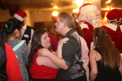 Tyler Meinke and Linda Kello slow dance to "Let it go" during the 13th annual Winterfest special needs dance, Wednesday, Dec. 6, 2017, at the Mahoning Country Club in Girard...(Nikos Frazier | The Vindicator)