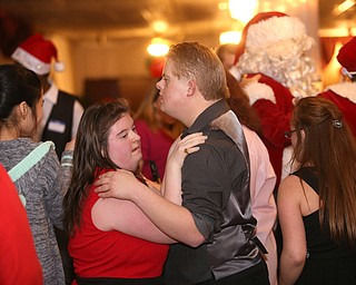 Tyler Meinke and Linda Kello slow dance to "Let it go" during the 13th annual Winterfest special needs dance, Wednesday, Dec. 6, 2017, at the Mahoning Country Club in Girard...(Nikos Frazier | The Vindicator)