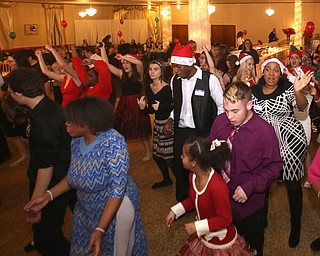 Students dance to the "Cupid Shuffle" during the 13th annual Winterfest special needs dance, Wednesday, Dec. 6, 2017, at the Mahoning Country Club in Girard...(Nikos Frazier | The Vindicator)