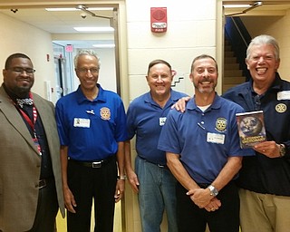 Austintown Rotary Club visited Austintown Intermediate School Nov. 1 and distributed 360 dictionaries to the third-graders, an annual project of the Rotary in the field of literacy. Rotarians above, from left, are Jeremy Batchelor, Ram Kasaganti, Gary Reel, John Mashiska and Bruce Laraway. At right, are Stuart Gibbs, business and investment librarian for the Public Library of Youngstown and Mahoning County, and Bruce Laraway, Rotary president. Gibbs explained that not only does the Main Branch on Wick Avenue provide traditional services but also has books on tape, games and puzzles, genealogy, the Baby Brilliant Program and more. Below, Laraway presents Gibbs a book that was donated to the Austintown Elementary School Library in his honor.
