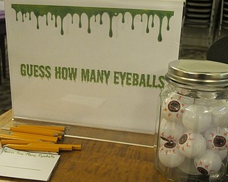 Neighbors | Zack Shively.Librarian Ashley Young organized an event at the Austintown library to commemorate the 25th anniversay of R.L. Stine's Goosebumps franchise. Young created many games for the event, including a guessing game of how many eyeballs fit into a jar.