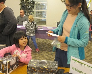 Neighbors | Zack Shively.Children placed their hands inside boxes to "guess the gross." The boxes had labels like "zombie brains" and "bat wing." They had to guess the actual item in the box, such as noodles for the zombie brains and beef jerky for the bat wings.