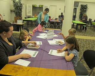 Neighbors | Zack Shively.Librarian Ashley Young laid out sheets for children to make their own Goosebumps book cover, similar to the R.L. Stine books on display in the room.