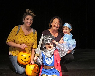 Neighbors | Zack Shively.The staff walked across stage and posed for pictures, as the students do during promenade. Principal Cynthia Fernback hosted the event to have a safe place for the families to trick-or-treat while also showcasing the children and families of the school staff. Pictured are, from left, (front) Andrew and Amilia Fernback; (back) Angelique Morris and Cythnia Fernback.