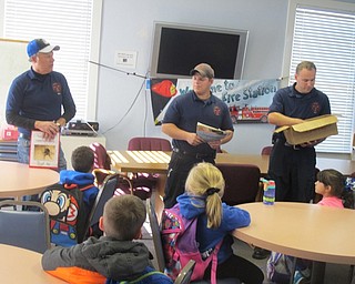 Neighbors | Zack Shively.Firefighters, from left, Bob Lidle, Jake Ezzo and Ian Harker talk to the students about being a firefighter on Oct. 27.