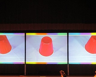 Neighbors | Zack Shively.Near the end of the talk, Camfel Productions played a game with the students. They had a ball under one cup on the screen and mixed the cups around. The cups moved very quickly and Olivia Lee, the presenter, had the students ask Candace Hutchson, the other presenter, for the answer. Their point was that the best way to know something is to ask.