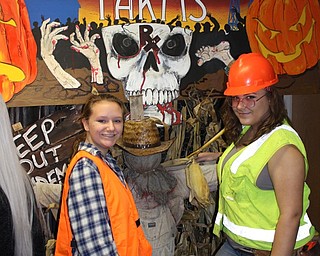 Neighbors | Abby Slanker.Canfield High School juniors Kalyn Duesenberry (left) and Stephanie Brown (right) dressed up as construction workers and waited in line to walk through the school’s annual Haunted House on Oct. 31.