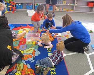 Neighbors | Zack Shively.Poland North Elementary held a program called "Mommy and Me" for young children. The children played after listening to a story. The children helped clean up the leaves after they played.
