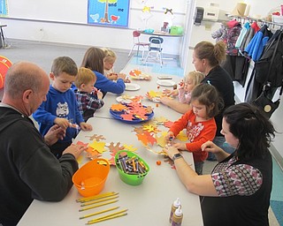 Neighbors | Zack Shively.Tiffany Vesey ran the "Mommy and Me" program at Poland North Elementary. She had the children do a project where they made a fall wreath by gluing paper leaves to a circle. The children pictured on the left, from front, are Cameron, Brooks and Elise. The children on the right, from front, are Adelaide and Tessa.