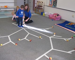 Neighbors | Zack Shively.Tiffany Vesey had the students walk along the tape to collect apples from the tree outline. The children had story time, play time, crafts and a snack.
