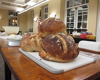 Neighbors | Zack Shively.Librarian Missy Williams brought no-knead bread she had made at home to show to those at the library's "No Need to Knead" event. Williams cut the bread and offered samples.