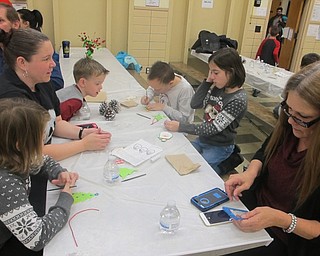 Neighbors | Zack Shively.Market Street Elementary School hosted its annual Breakfast with Santa on Dec. 2. Pictured, a family works on making a Santa ornament for their Christmas tree.