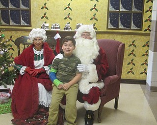 Neighbors | Zack Shively.Market Street Elementary School's PTA organized the Breakfast with Santa. They set up an area at the end of a hall for children to take pictures with Mr. and Mrs. Claus. Pictured, Tony Sarkis-Carr sits on Santa's lap.