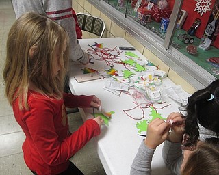 Neighbors | Zack Shively.The Market Street Elementary PTA had two crafts at the event. The children glued together a Santa ornament for one craft. The students scratched off a layer of a green Christmas tree ornament to reveal a rainbow underneath. The children scraped designs into the trees.