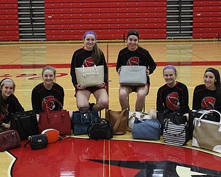 Neighbors | Abby Slanker.Members of the Canfield High School girls basketball team displayed several designer handbags which will be given as prizes at Designer Bag Bingo at St. Michaels Parish Family Life Center Jan. 20.