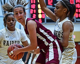 WARREN, OHIO - DECEMBER 7, 2017: Boardman's Emma Tokarsky spins while protecting the ball from Harding's Diamond Phillips, right, and Toni Donaldson during the first half of their game, Thursday night at Warren Harding High School. DAVID DERMER | THE VINDICATOR