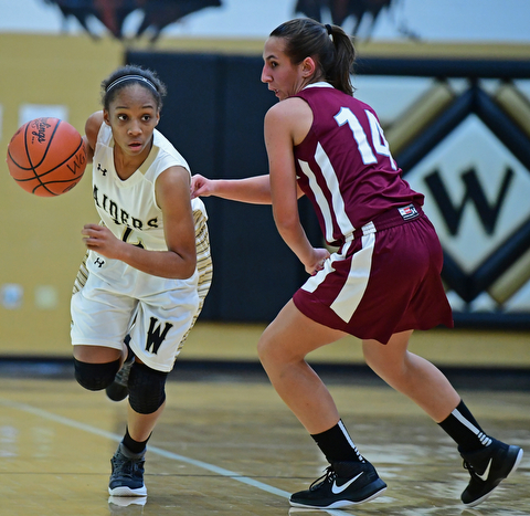 WARREN, OHIO - DECEMBER 7, 2017: Harding's Diamond Phillips drives on Boardman's Emma Tokarsky during the first half of their game, Thursday night at Warren Harding High School. DAVID DERMER | THE VINDICATOR