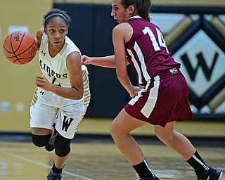 WARREN, OHIO - DECEMBER 7, 2017: Harding's Diamond Phillips drives on Boardman's Emma Tokarsky during the first half of their game, Thursday night at Warren Harding High School. DAVID DERMER | THE VINDICATOR