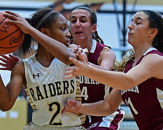 WARREN, OHIO - DECEMBER 7, 2017: Harding's Diamond Phillips looks to pressure the ball while being pressured by Boardman's Emma Tokarsky and Alicia Saxton during the first half of their game, Thursday night at Warren Harding High School. DAVID DERMER | THE VINDICATOR