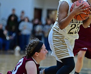 WARREN, OHIO - DECEMBER 7, 2017: Harding's Brayleonna Woods dribbles away from Boardman's Annaliisa Cordova while taking the ball away from her during the first half of their game, Thursday night at Warren Harding High School. DAVID DERMER | THE VINDICATOR