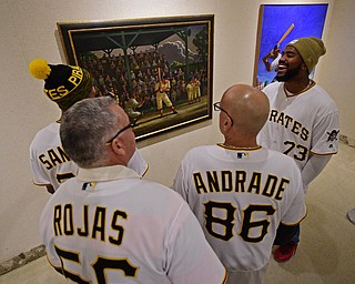 YOUNGSTOWN, OHIO - DECEMBER 7, 2017: Pittsburgh Pirates Felipe Rivero, right, smiles while looking at a painting with Edgar Santana, Euclides Rojas and Heberto Andrade inside of the sports room, Thursday morning at the Butler Institute of Art during the Pirates Care-A-Van tour. DAVID DERMER | THE VINDICATOR