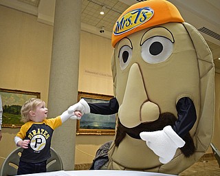 YOUNGSTOWN, OHIO - DECEMBER 7, 2017: Timmy Kaufman, 1, of New Castle smiles while getting a hand shake from Bacon Burt the Pierogi, Thursday morning at the Butler Institute of Art during the Pirates Care-A-Van tour. DAVID DERMER | THE VINDICATOR