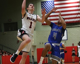 Struthers' Isaiah Torrence (1) goes up for a layup against Hubbard's Davion Daniels (4) in the first quarter of an AAC high school basketball game against TEAM, Friday, Dec. 8, 2017, in Struthers. Hubbard won 70-55...(Nikos Frazier | The Vindicator)