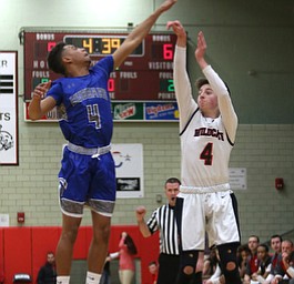 Struthers' Jared Laczko (4) goes up for three as Hubbard's Davion Daniels (4) attempts to block his shot in the first quarter of an AAC high school basketball game, Friday, Dec. 8, 2017, in Struthers. Hubbard won 70-55...(Nikos Frazier | The Vindicator)