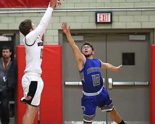 Hubbard's Zach Resatar (10) attempts to block Struthers' Trey Metzka (11) three point shot in the second quarter of an AAC high school basketball game, Friday, Dec. 8, 2017, in Struthers. Hubbard won 70-55...(Nikos Frazier | The Vindicator)