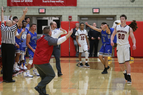 Both benches react after a basket in the third quarter of an AAC high school basketball game between Hubbard and Struthers High Schools, Friday, Dec. 8, 2017, in Struthers. Hubbard won 70-55...(Nikos Frazier | The Vindicator)