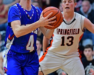 NEW MIDDLETOWN, OHIO - DECEMBER 8, 2017: Western Reserve's Nic Corbett goes to the basket against Springfield's John Ritter during the first half of their game, Friday night at Springfield High School. DAVID DERMER | THE VINDICATOR