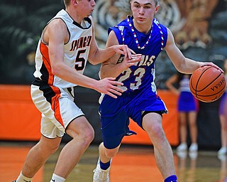 NEW MIDDLETOWN, OHIO - DECEMBER 8, 2017: Western Reserve's Cole DeZee drives on Springfield's Clay Medvec during the first half of their game, Friday night at Springfield High School. DAVID DERMER | THE VINDICATOR