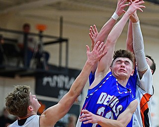 NEW MIDDLETOWN, OHIO - DECEMBER 8, 2017: Western Reserve's Cole DeZee reaches up for a rebound over Springfield's Evan Ohlin during the first half of their game, Friday night at Springfield High School. DAVID DERMER | THE VINDICATOR
