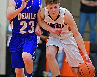 NEW MIDDLETOWN, OHIO - DECEMBER 8, 2017: Springfield's Evan Ohlin drives on Western Reserve's Cole DeZee during the 2nd half of their game, Friday night at Springfield High School. DAVID DERMER | THE VINDICATOR