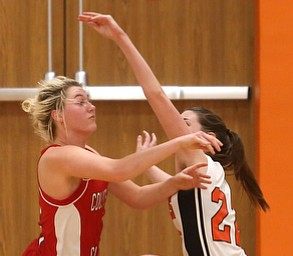 Columbiana's Tessa Liggett (5) and Mineral Ridge forward Fran Kesner (22) fight for the ball in the third quarter of a high school basketball game, Saturday, Dec. 9, 2017, in Mineral Ridge. Columbiana won 70-32...(Nikos Frazier | The Vindicator)